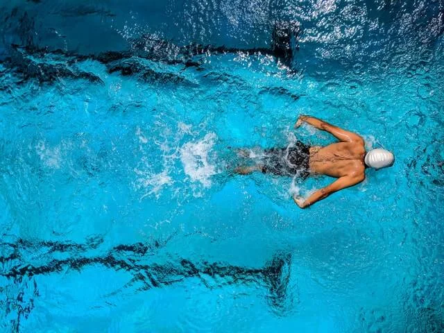 Sports science student swimming in a pool.